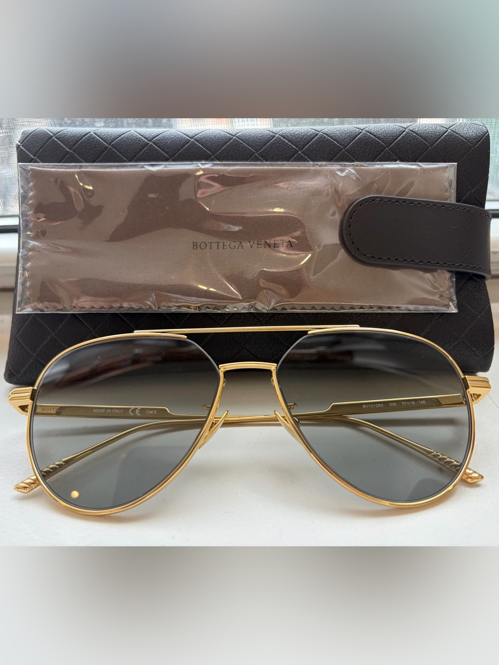 Bottega Veneta Gold Frame Sunglasses with Blue Tinted Lenses
